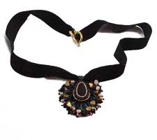 Black and gold sea glass pendant on velvet ribbon